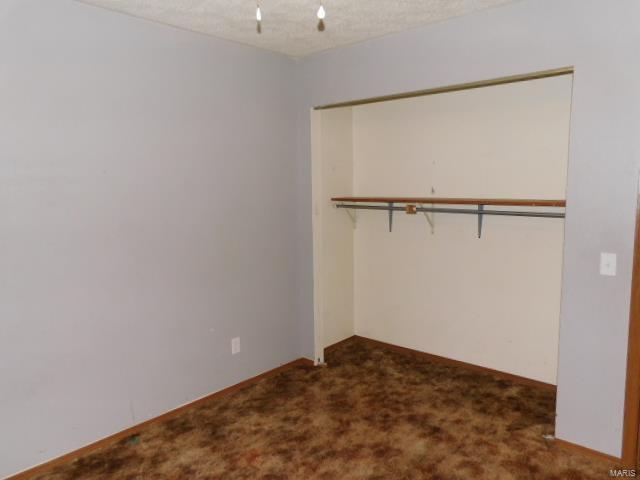 unfurnished bedroom with a closet and carpet