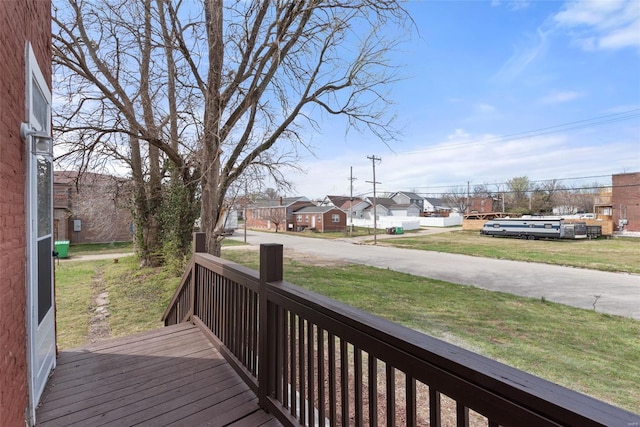 deck featuring a residential view and a yard