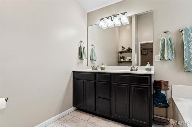 6833 Brandywine Ct, Fairview Heights, IL 62208 - full bathroom with marble look tiles, a tub to relax in, double vanity, and baseboards