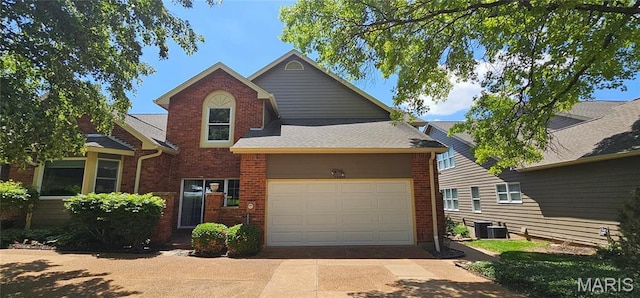 traditional-style home with brick siding, concrete driveway, and central AC