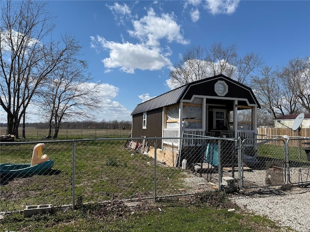 219 S W St, Brownstown, IL 62418 - view of front of home with a fenced front yard, a gate, and a gambrel roof