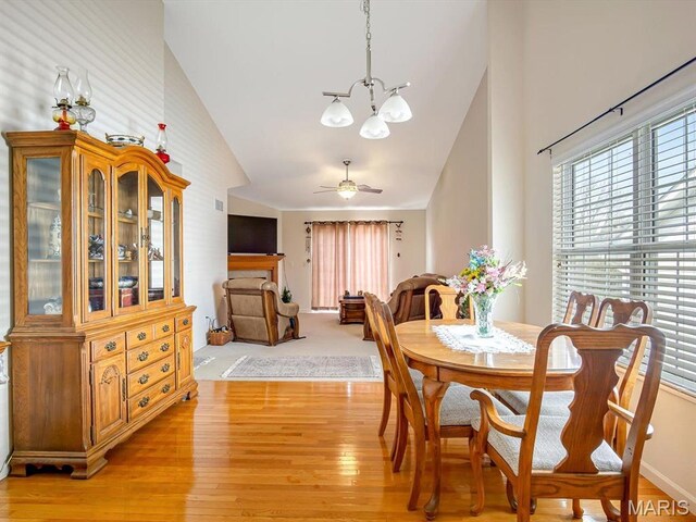 105 Megan Ct, Valmeyer, IL 62295 - dining space featuring a chandelier, high vaulted ceiling, light wood finished floors, and a ceiling fan