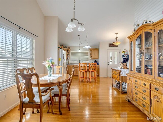 105 Megan Ct, Valmeyer, IL 62295 - dining room featuring light wood-type flooring, baseboards, and a chandelier