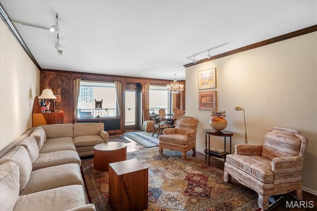 4466 W Pine Blvd Unit 15C, Saint Louis, MO 63108 - living room featuring track lighting, a chandelier, crown molding, and baseboards