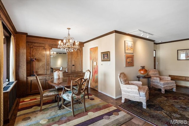4466 W Pine Blvd Unit 15C, Saint Louis, MO 63108 - dining space featuring baseboards, a chandelier, crown molding, track lighting, and wood finished floors