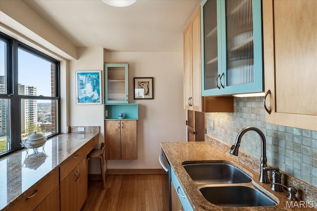 4466 W Pine Blvd Unit 15C, Saint Louis, MO 63108 - kitchen with a sink, healthy amount of natural light, dark wood-style floors, and light stone counters