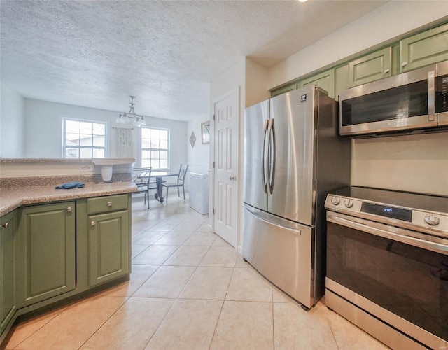 840 Herndon Rd, Lebanon, MO 65536 - kitchen featuring green cabinetry, stainless steel appliances, light tile patterned flooring, a textured ceiling, and a chandelier