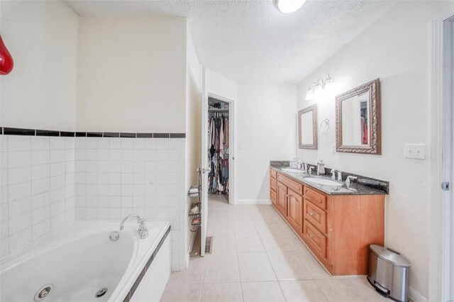 840 Herndon Rd, Lebanon, MO 65536 - bathroom with a textured ceiling, a whirlpool tub, tile patterned floors, double vanity, and a walk in closet