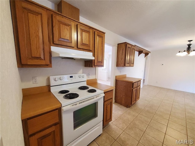 528 Dogwood Ln, Houston, MO 65483 - kitchen with white range with electric cooktop, under cabinet range hood, brown cabinets, a chandelier, and light tile patterned floors