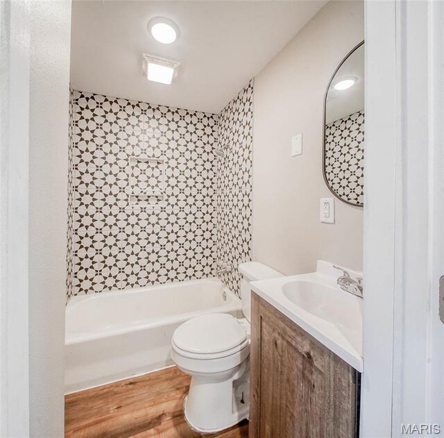 713 N Oak St, Salem, MO 65560 - full bath featuring toilet, wood finished floors, vanity, and washtub / shower combination