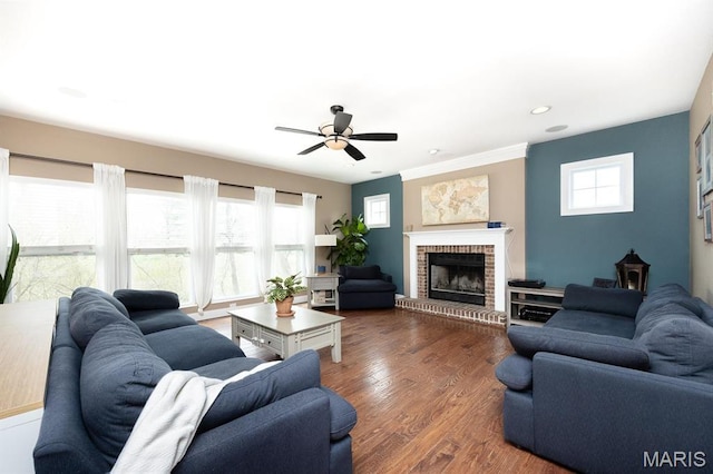 living room with a ceiling fan, a brick fireplace, dark wood-style flooring, and recessed lighting