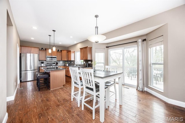 dining area with baseboards, dark wood-style floors, and recessed lighting