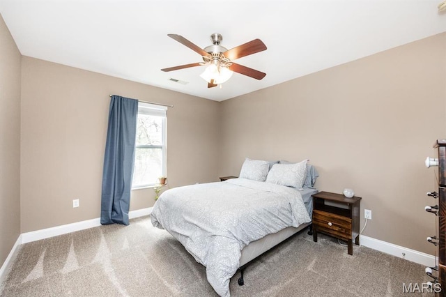 carpeted bedroom with baseboards and a ceiling fan