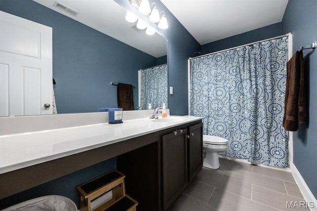 full bathroom featuring toilet, tile patterned floors, vanity, and baseboards