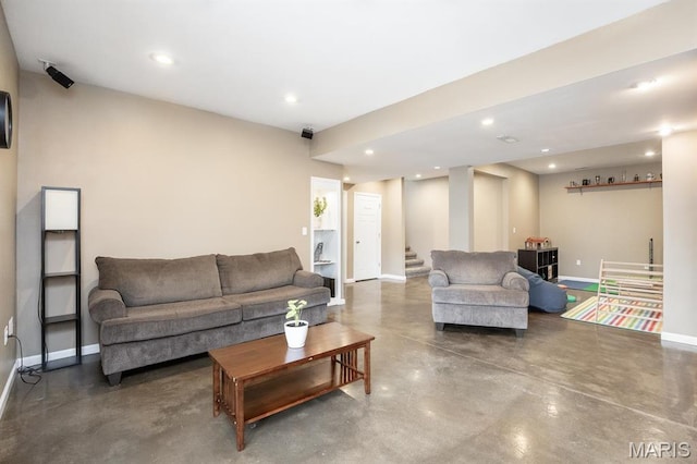 living area with baseboards, stairway, finished concrete floors, and recessed lighting