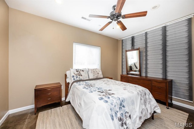 bedroom with baseboards and a ceiling fan