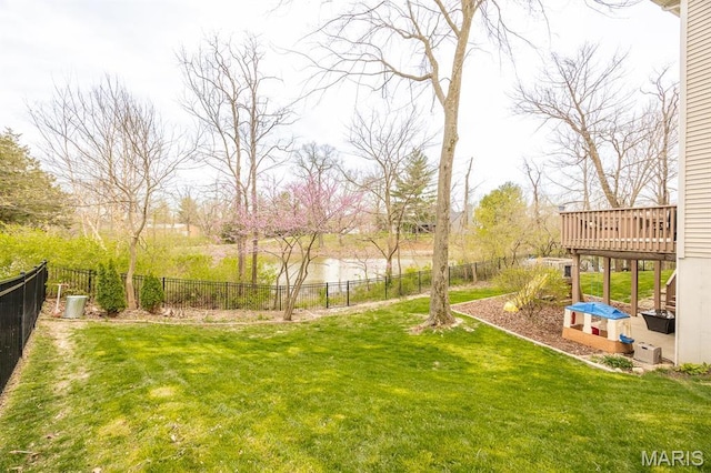 view of yard with a deck with water view