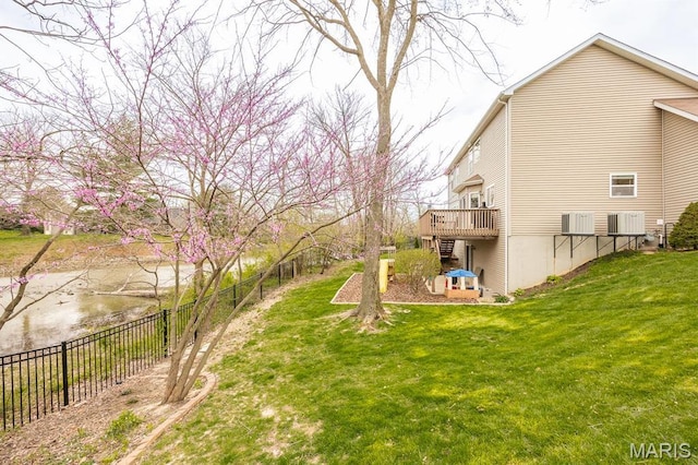 view of yard featuring a deck, central air condition unit, and stairs