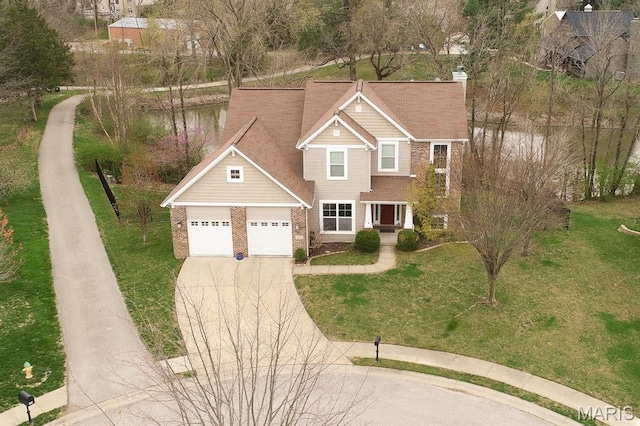 traditional home featuring driveway, a front lawn, a garage, brick siding, and a chimney