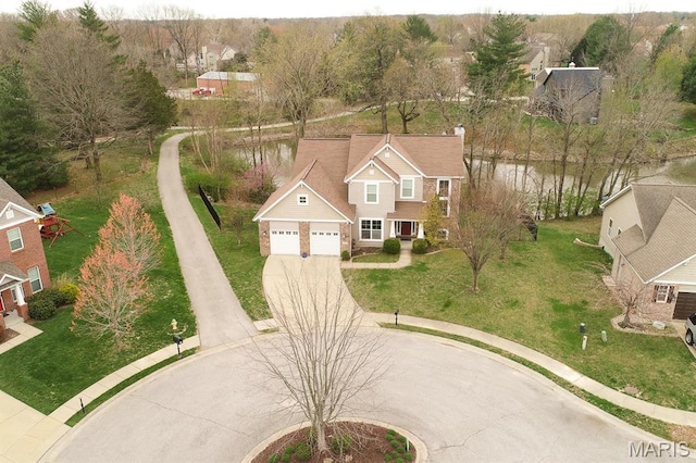 aerial view of residential area featuring a large body of water