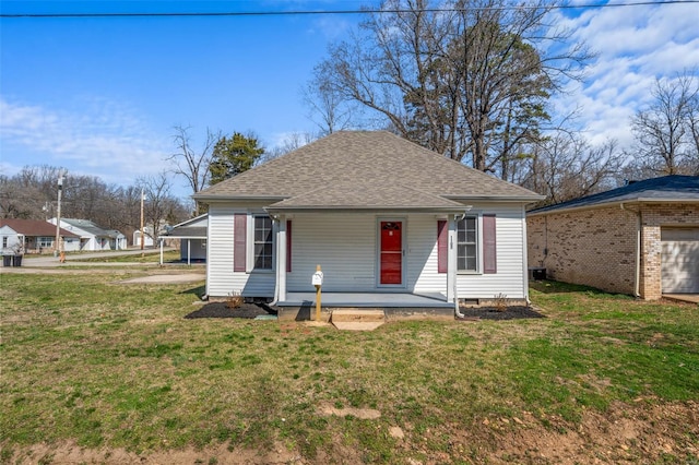 1107 Hickory St, Poplar Bluff, MO 63901 - bungalow featuring a porch, a front yard, roof with shingles, and a garage