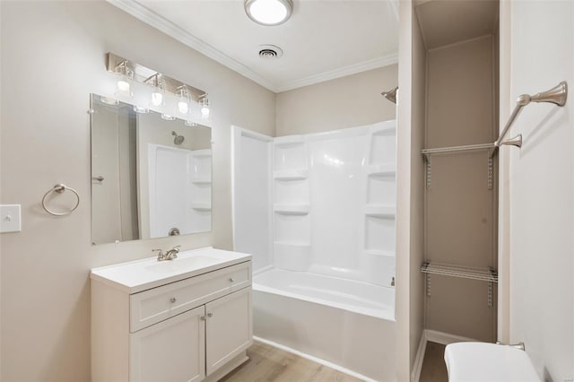 1107 Hickory St, Poplar Bluff, MO 63901 - full bathroom with wood finished floors, vanity, shower / washtub combination, ornamental molding, and toilet