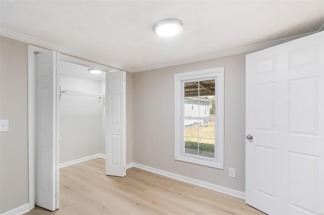 1107 Hickory St, Poplar Bluff, MO 63901 - unfurnished bedroom featuring light wood-style floors, baseboards, ornamental molding, and a closet