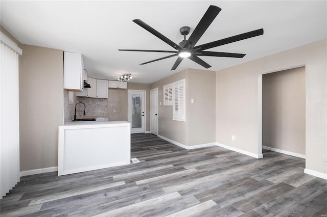 3438 Pine Grove Ave, Saint Louis, MO 63121 - unfurnished living room with a sink, ceiling fan, baseboards, and wood finished floors