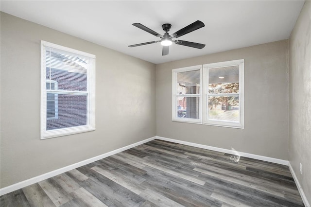 3438 Pine Grove Ave, Saint Louis, MO 63121 - unfurnished room featuring dark wood-style flooring, baseboards, and a ceiling fan