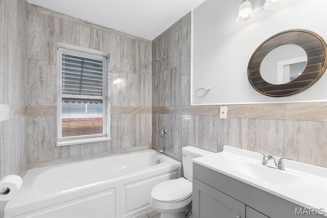 bathroom featuring toilet, shower / washtub combination, vanity, and tile walls