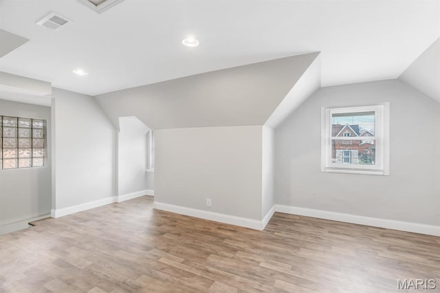 bonus room featuring lofted ceiling, light wood finished floors, baseboards, and recessed lighting