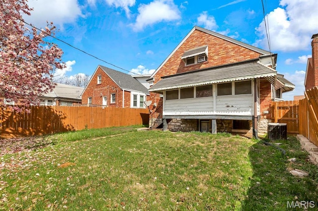 rear view of house featuring brick siding and central AC unit