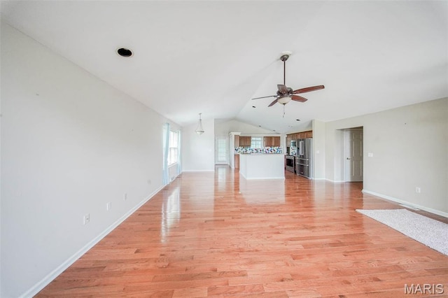 1106 Grandsir Ave, Rolla, MO 65401 - unfurnished living room featuring ceiling fan, lofted ceiling, light wood-style floors, and baseboards
