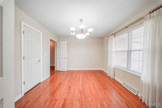 1106 Grandsir Ave, Rolla, MO 65401 - unfurnished room with light wood-style flooring, a chandelier, and baseboards