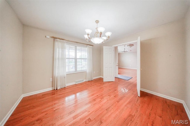 1106 Grandsir Ave, Rolla, MO 65401 - empty room with a chandelier, light wood-type flooring, and baseboards
