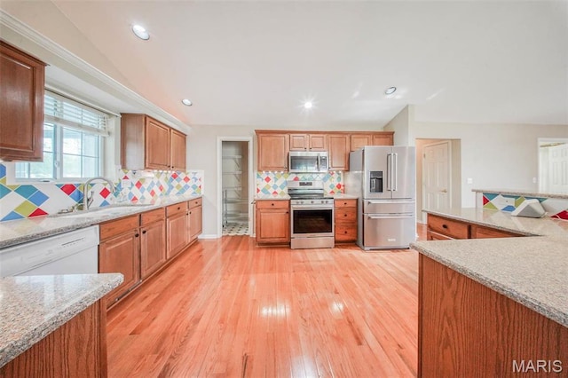 1106 Grandsir Ave, Rolla, MO 65401 - kitchen with stainless steel appliances, a sink, light wood-type flooring, decorative backsplash, and recessed lighting