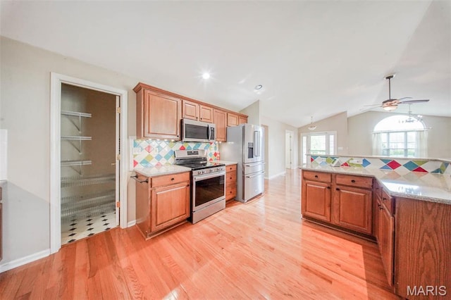1106 Grandsir Ave, Rolla, MO 65401 - kitchen with appliances with stainless steel finishes, tasteful backsplash, ceiling fan, light wood-style flooring, and lofted ceiling
