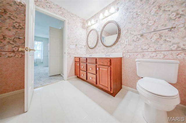 1106 Grandsir Ave, Rolla, MO 65401 - bathroom featuring wallpapered walls, vanity, and toilet