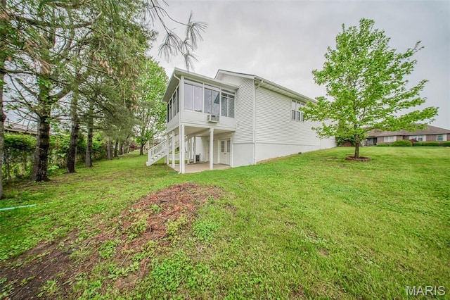 1106 Grandsir Ave, Rolla, MO 65401 - rear view of property with a patio, a sunroom, a yard, and stairway