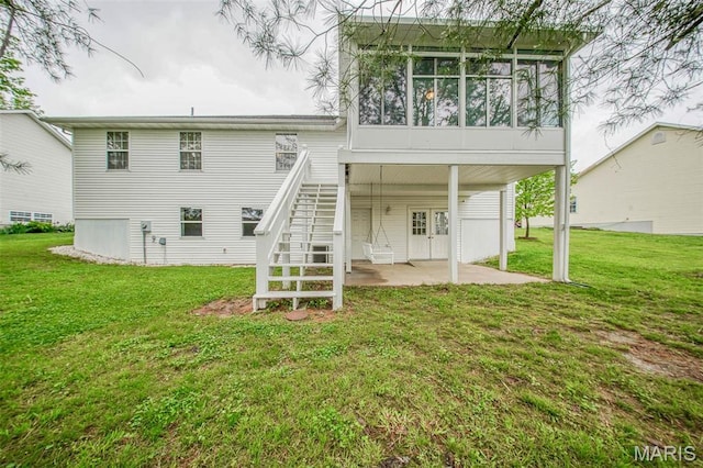 1106 Grandsir Ave, Rolla, MO 65401 - back of house featuring a patio area, a yard, stairs, and a sunroom
