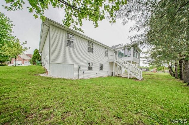 1106 Grandsir Ave, Rolla, MO 65401 - back of house with a yard, stairway, a sunroom, and a deck