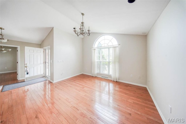 1106 Grandsir Ave, Rolla, MO 65401 - empty room featuring a chandelier, light wood-type flooring, baseboards, and lofted ceiling