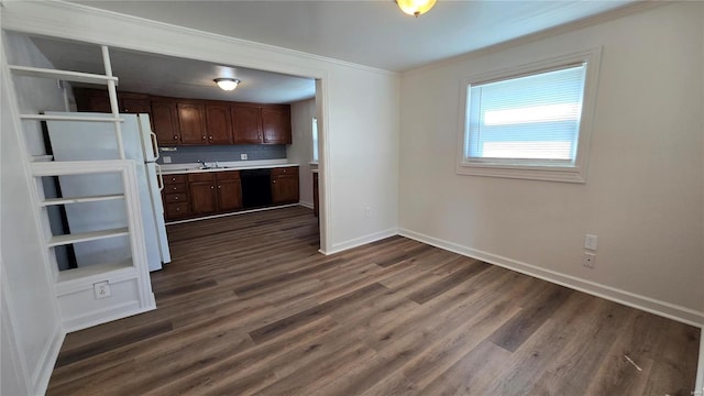 3240 Airway Ave, Saint Louis, MO 63114 - kitchen with ornamental molding, light countertops, baseboards, dark wood-style floors, and black dishwasher