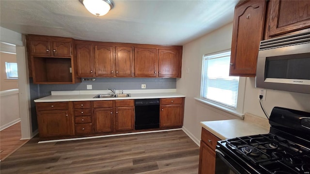 3240 Airway Ave, Saint Louis, MO 63114 - kitchen featuring black appliances, a sink, brown cabinets, dark wood finished floors, and open shelves