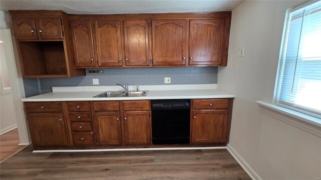 3240 Airway Ave, Saint Louis, MO 63114 - kitchen featuring black dishwasher, a sink, healthy amount of natural light, and dark wood-style flooring