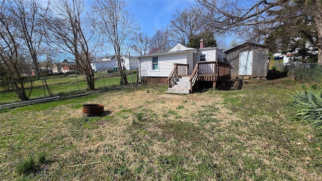 3240 Airway Ave, Saint Louis, MO 63114 - view of yard featuring a shed, a wooden deck, and an outbuilding