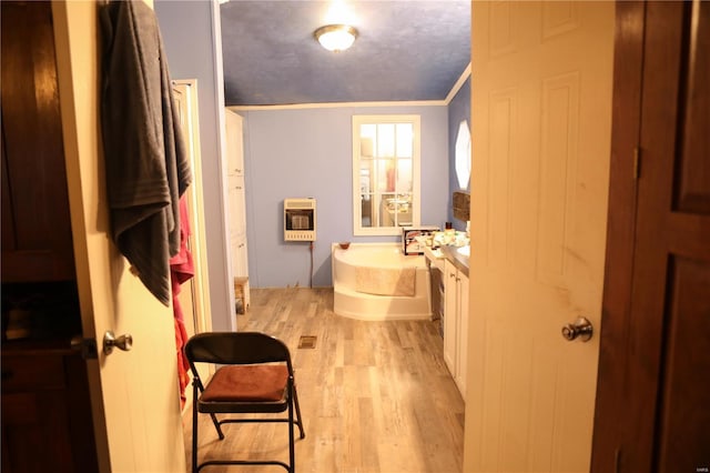 25125 Ash Dr, Grovespring, MO 65662 - full bath featuring wood finished floors, heating unit, a garden tub, ornamental molding, and vanity