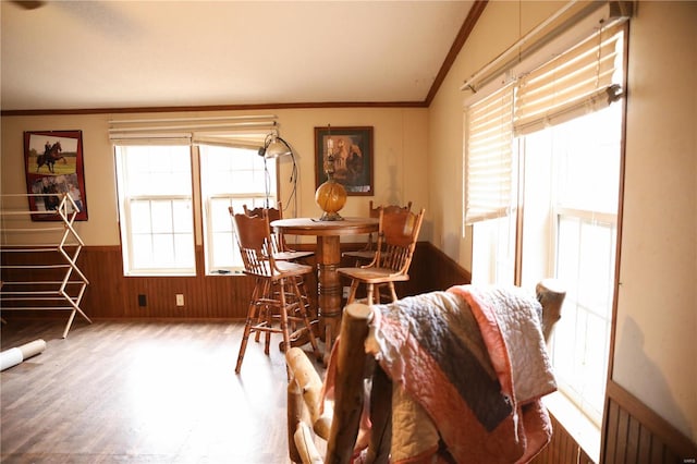 25125 Ash Dr, Grovespring, MO 65662 - dining area featuring crown molding, wainscoting, wooden walls, lofted ceiling, and wood finished floors