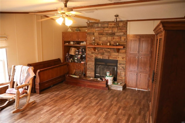 25125 Ash Dr, Grovespring, MO 65662 - living area featuring a stone fireplace, ceiling fan, wood finished floors, a decorative wall, and ornamental molding