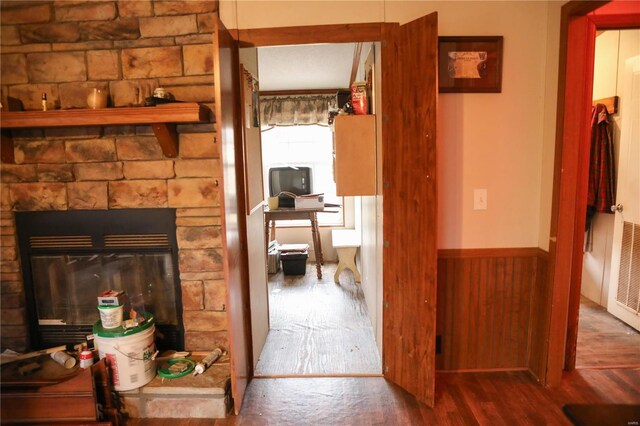 25125 Ash Dr, Grovespring, MO 65662 - detailed view of wood finished floors, a wainscoted wall, and a stone fireplace